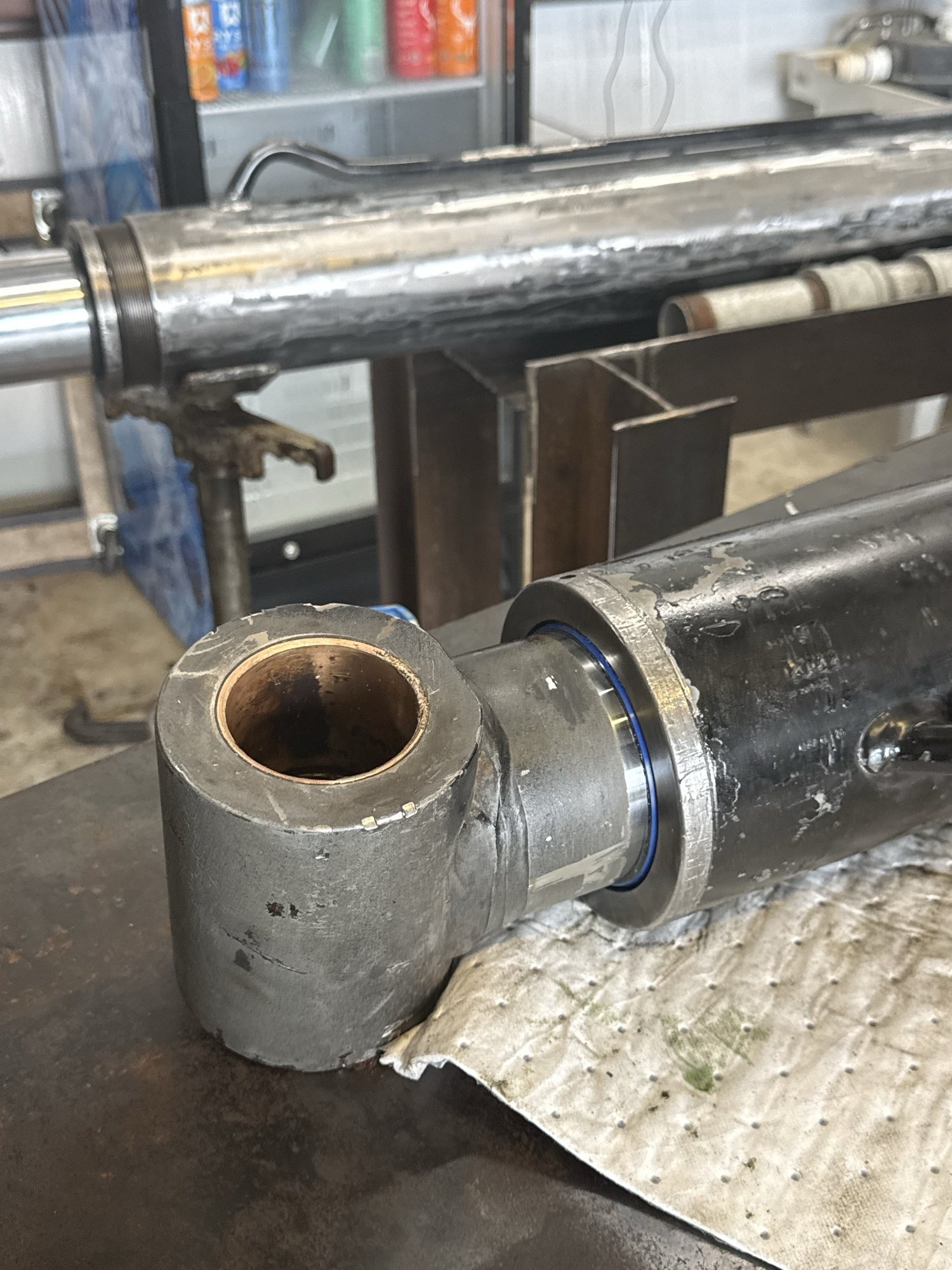 Close detail of a hydraulic cylinder eye and chrome rod