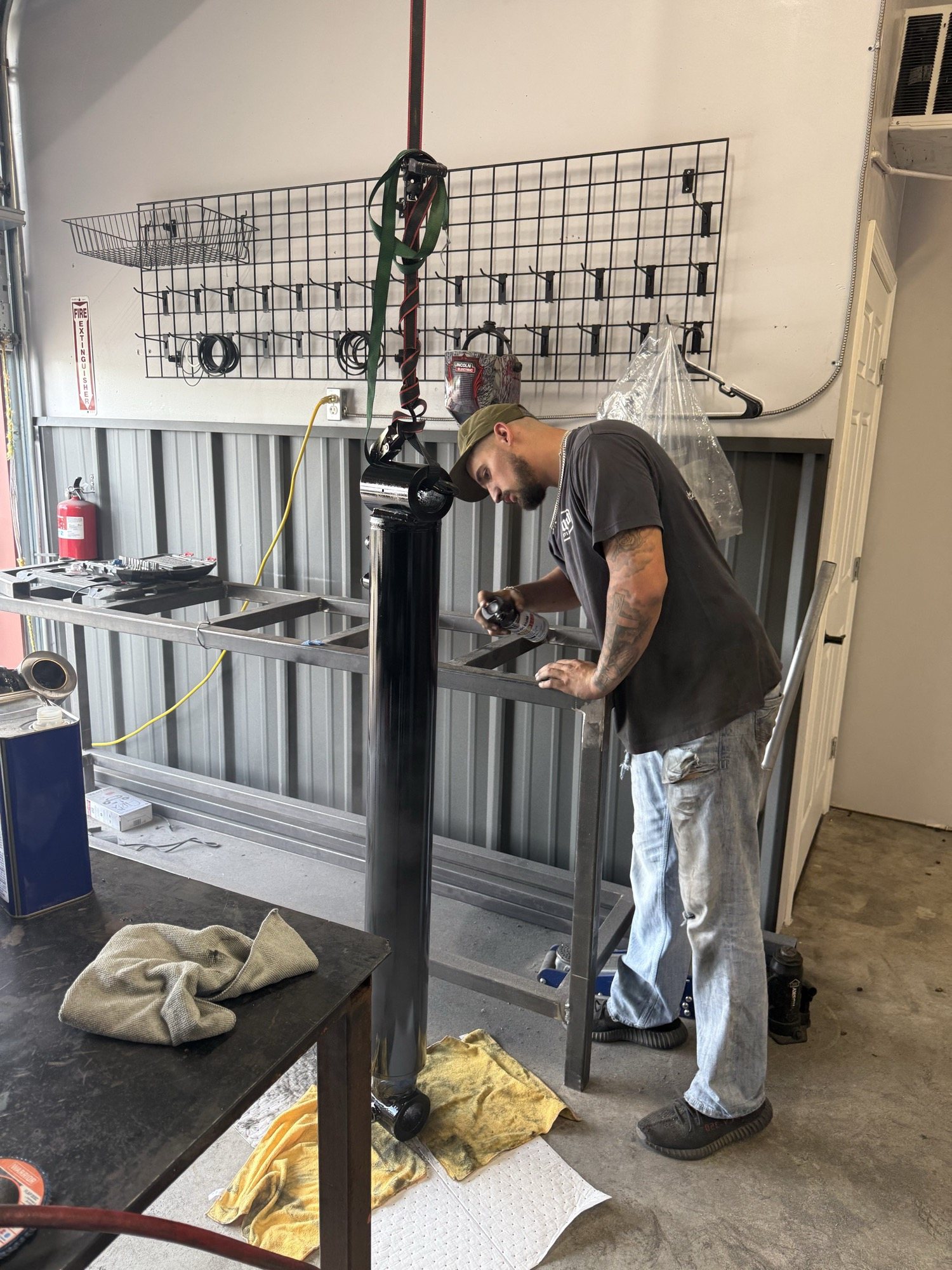 Technician working on a vertical hydraulic cylinder