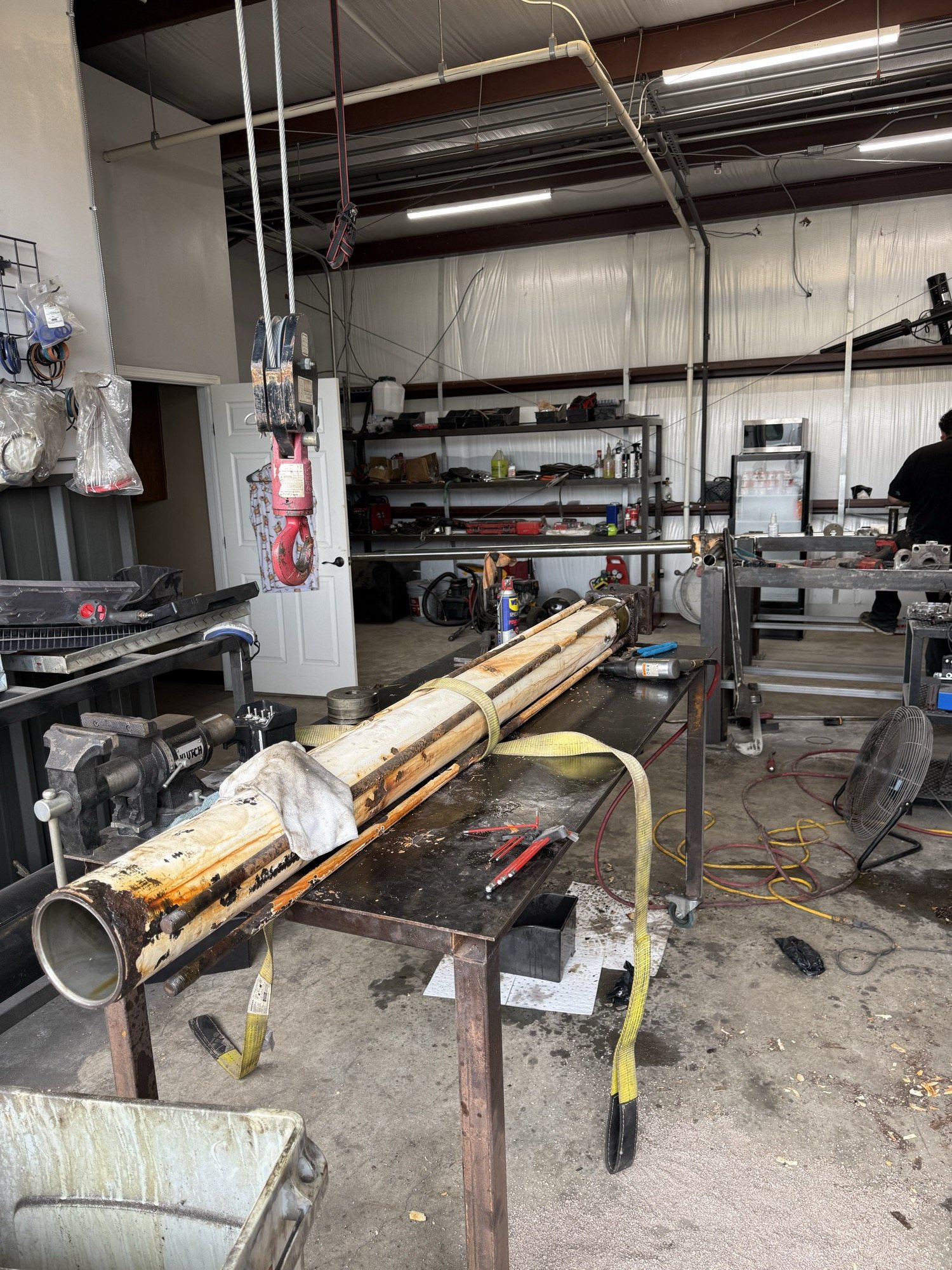Long yellow hydraulic cylinder on a repair table