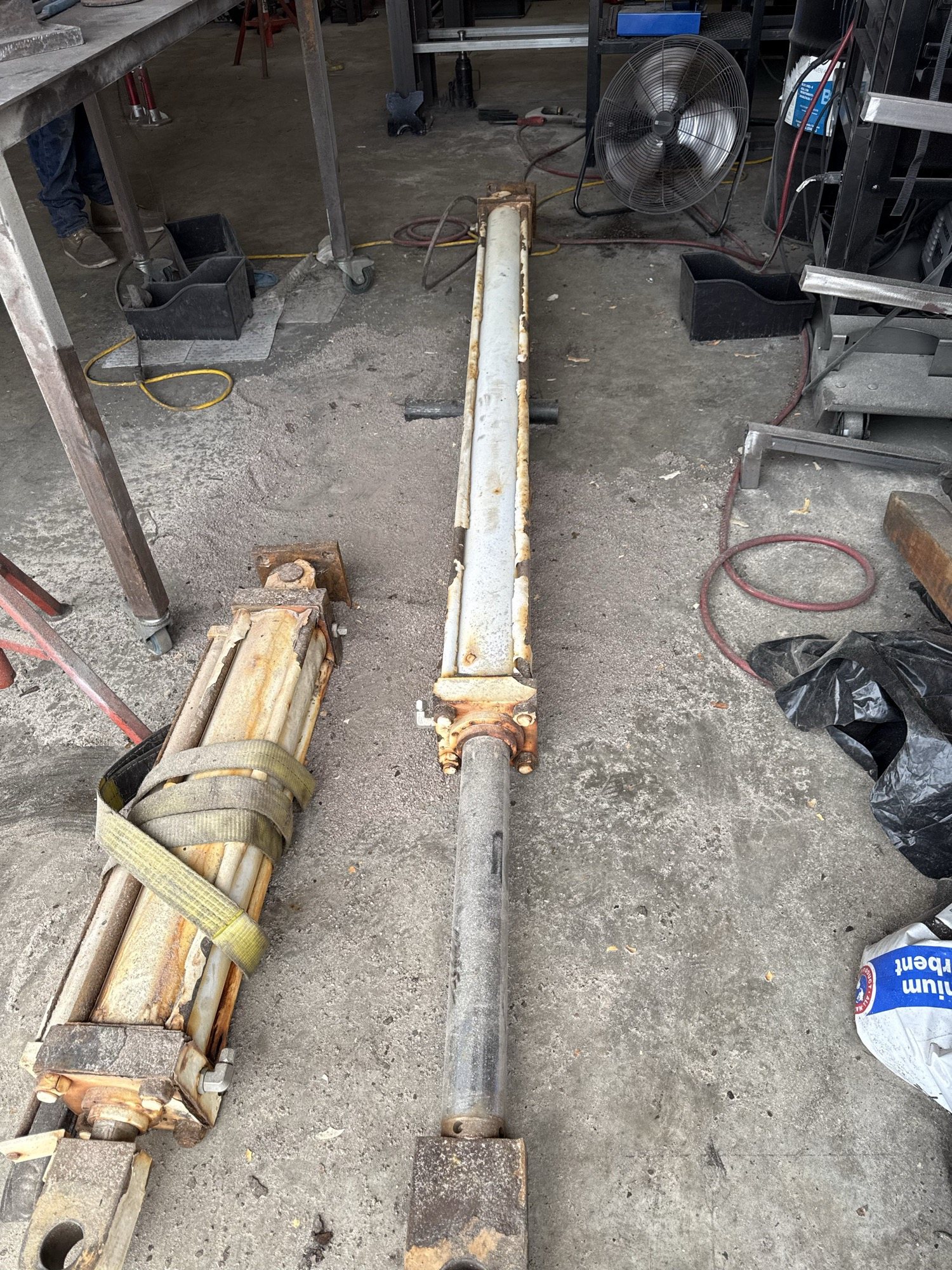 Disassembled hydraulic cylinders and rods ready for repair